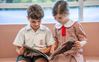Two students from Holy Cross Catholic Primary School Woollahra read a book together